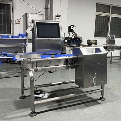 Operator interacting with touchscreen PC interface of dynamic checkweigher for easy setup